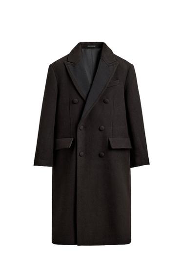 Front view of a dark brown coat with contrasting peak lapels, a double-breasted fastening, a chest pocket and flap pockets at the hip.
