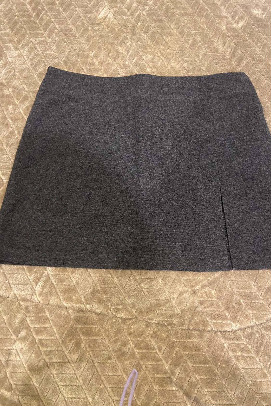 Front view of grey short skirt with side slit.