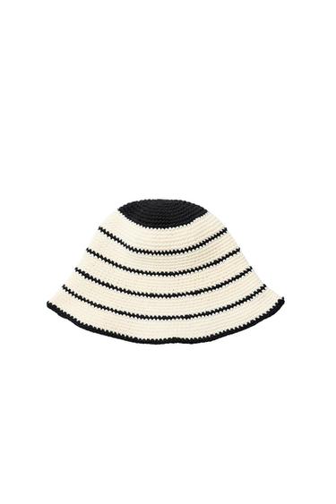 White crochet bucket hat with black horizontal stripes, with a black crown and brim, on a white background.