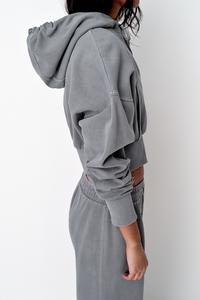 Sweatshirt with adjustable drawstring hood. Long sleeves with