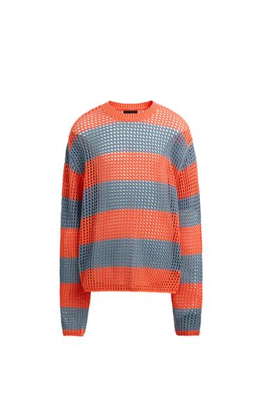 Front view of a wide striped jumper in orange and grey with an open knit.