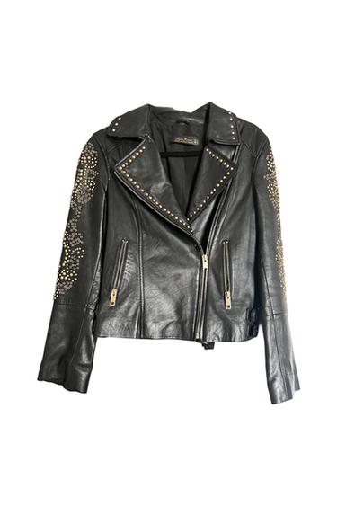 Black biker jacket with an asymmetrical zipper and pockets. Featuring decorative gold studs on the sleeves and lapels. Zara Woman.