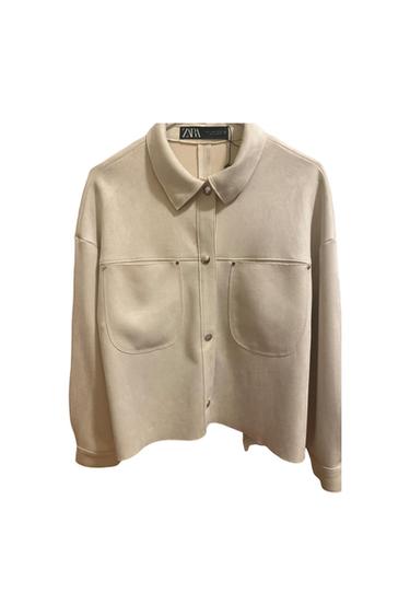 Front view of a beige jacket with front pockets and button closure.