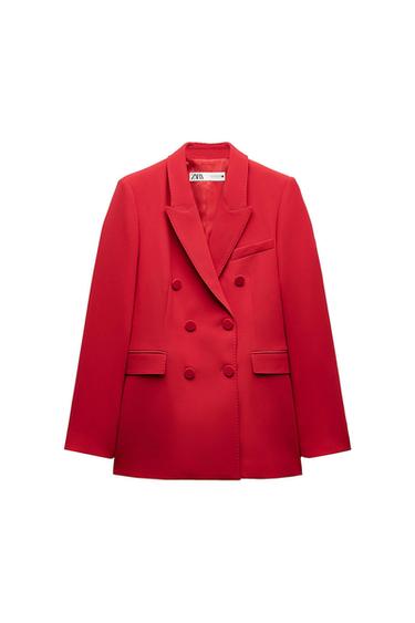 Red double-breasted jacket with wide lapels and front pockets. Visible label on the inside of the collar.