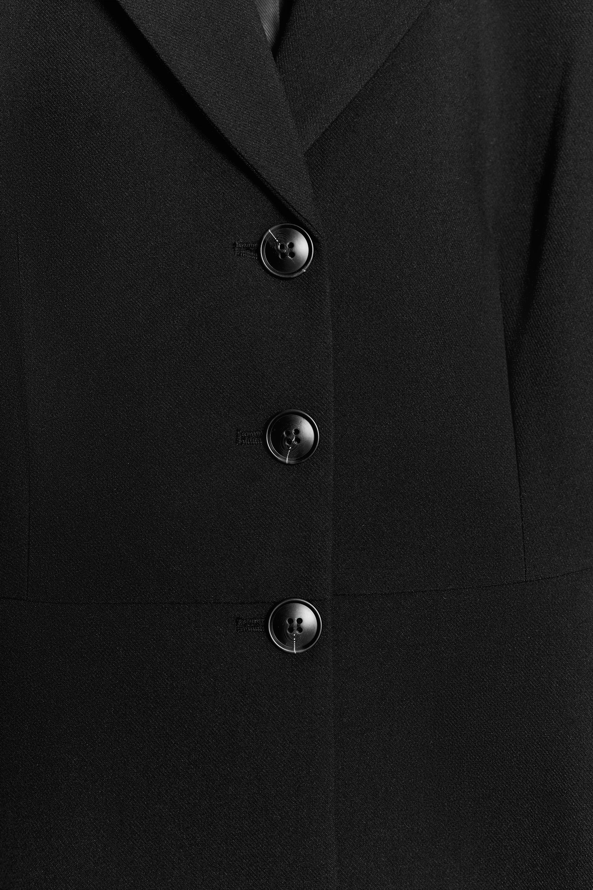 VESTE PEPLUM À ÉPAULETTES