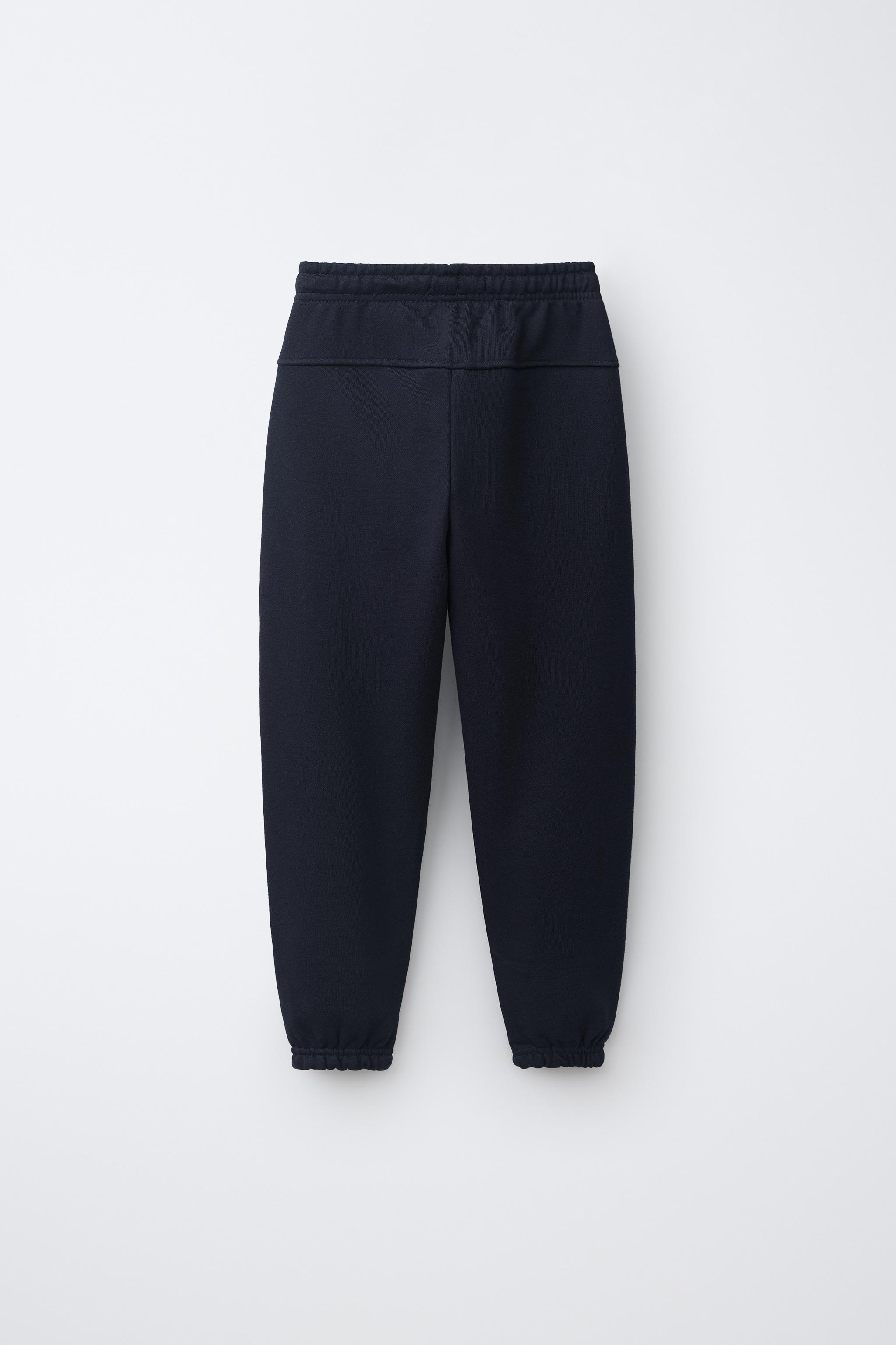 PANTALON DE JOGGING EN MOLLETON UNI AVEC ÉTIQUETTE