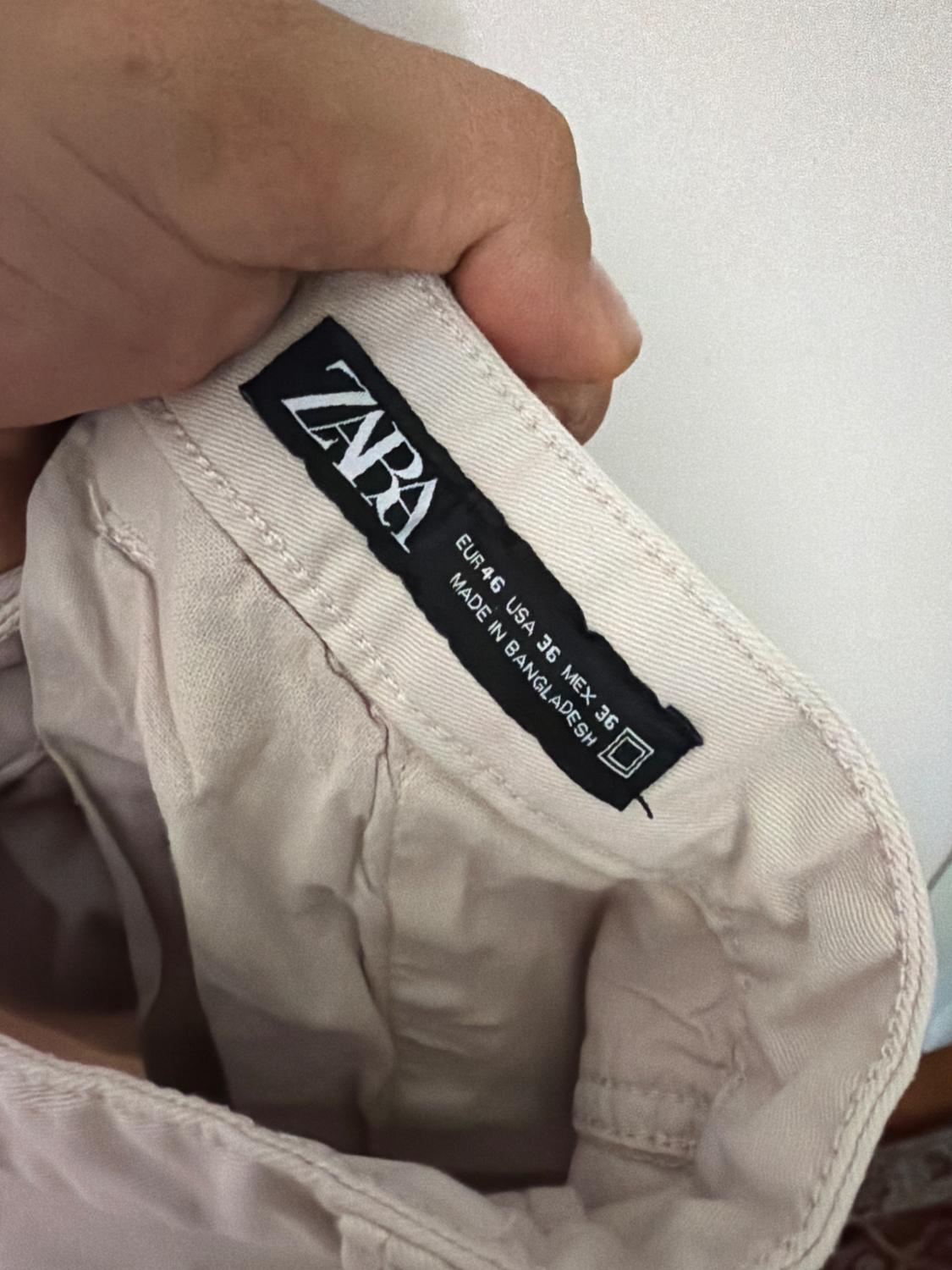 Elastic waistband shorts. Front pockets and back flap pockets. Flap patch pockets at legs. Front zip and button closure. - Image 3