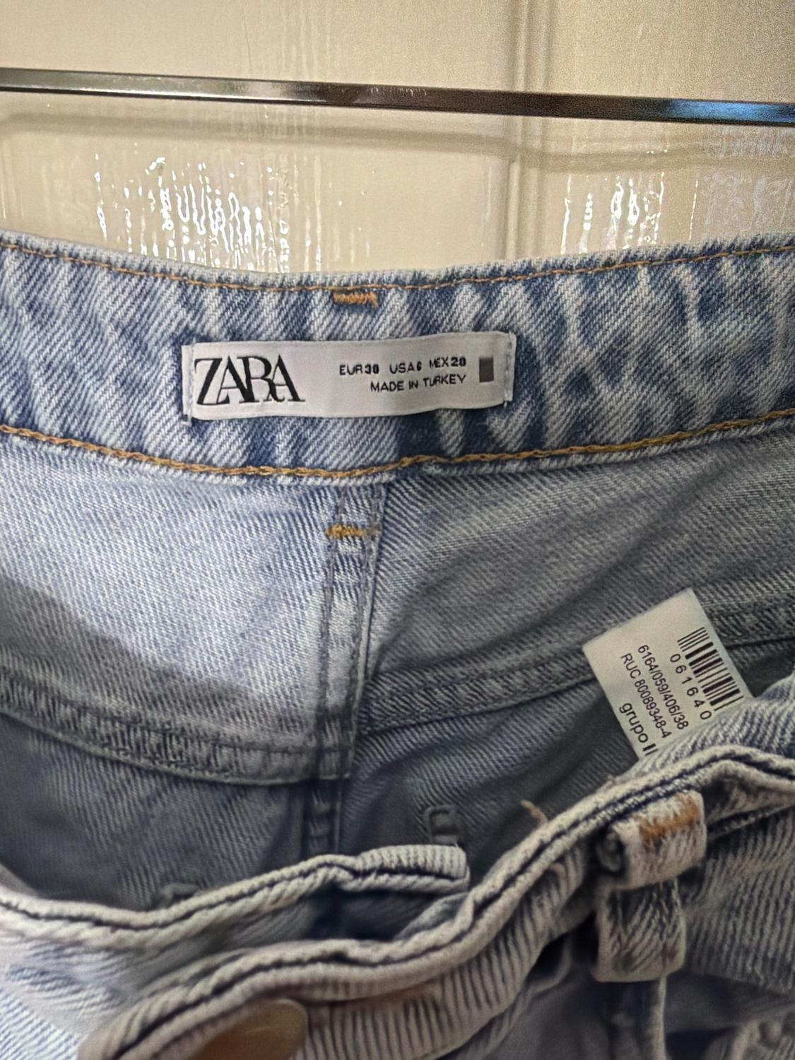 ZARA jeans label in light blue denim, showing sizes EUR 38, USA 6, MEX 28, and "MADE IN TURKEY".