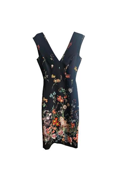 Sleeveless black dress with a V-neck and multicoloured floral print, denser at the bottom, on a white background.
