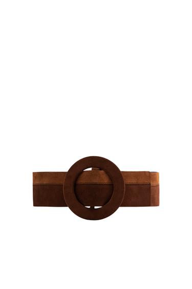 Wide brown belt with large circular buckle in front view.