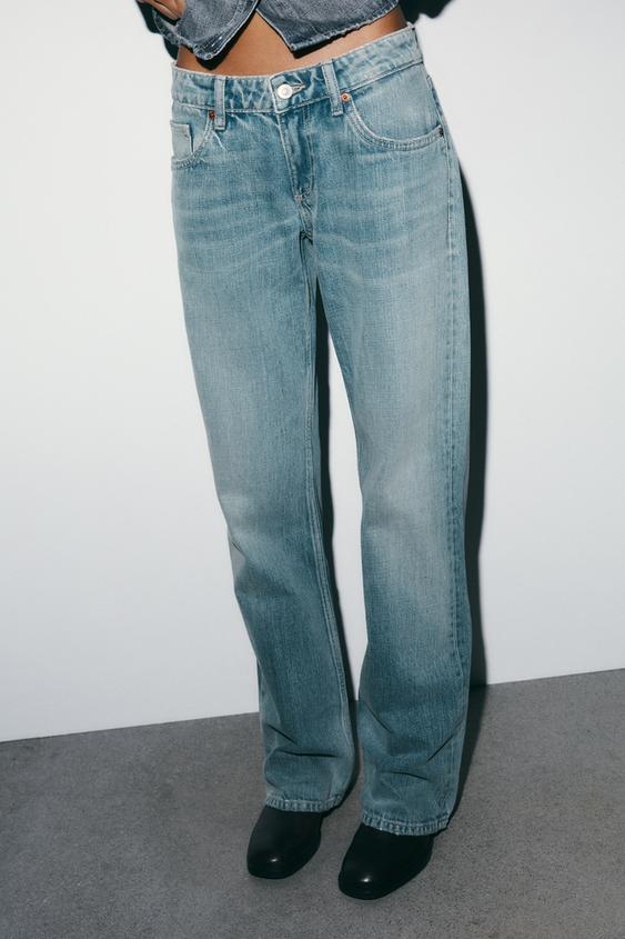 St�edn� detail sv�tle modr�ch d��n� s p�edn�mi a zadn�mi kapsami, zap�n�n�m na knofl�k a zip.