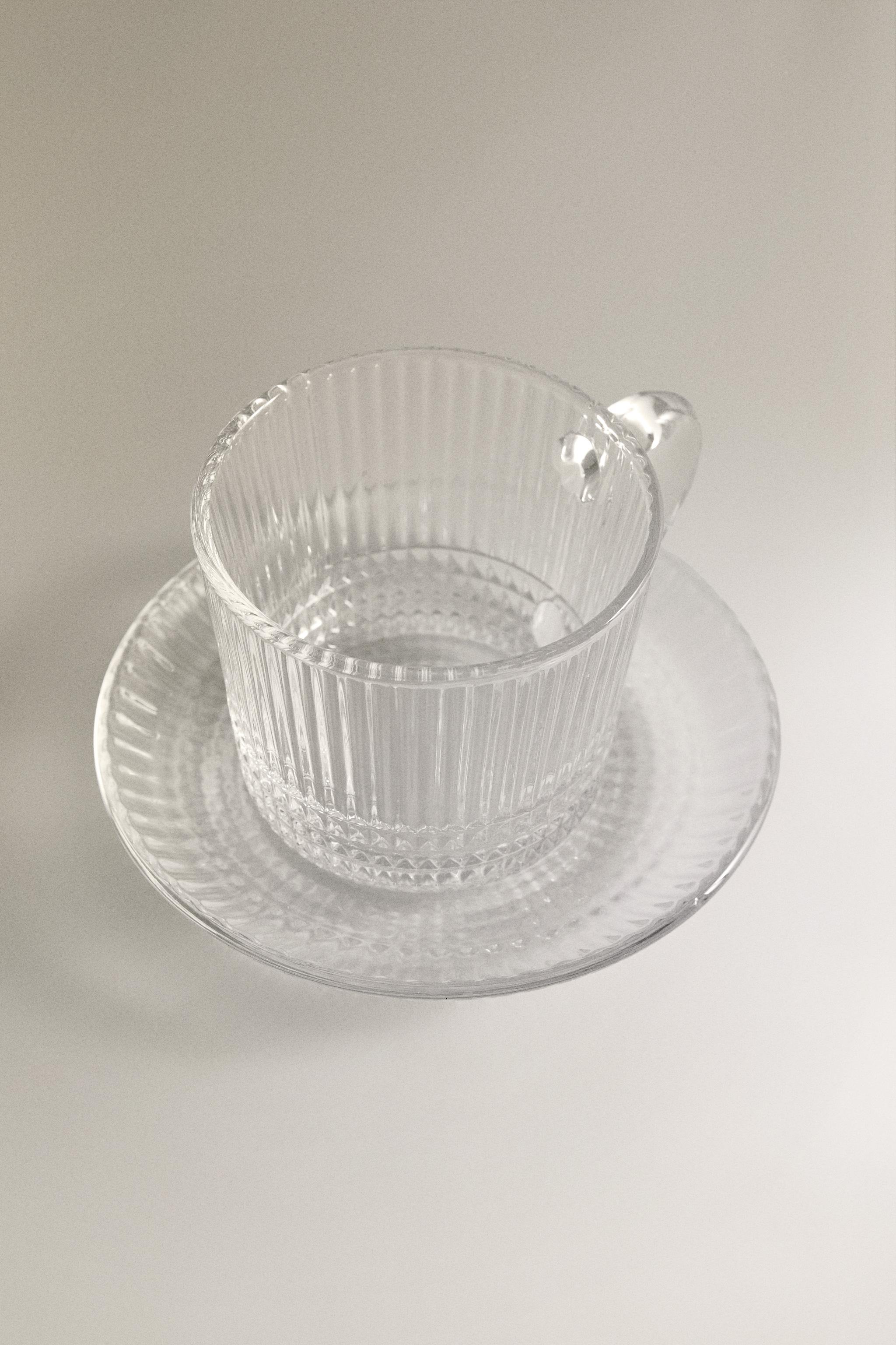 GLASS COFFEE CUP WITH SAUCER AND RAISED GEOMETRIC DESIGN. — Transparent