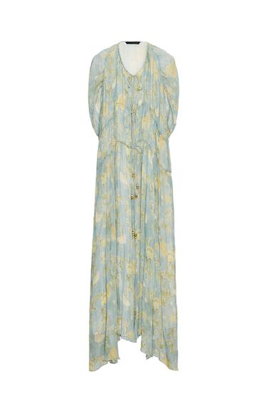 Front view of a long blue dress with floral print and tie detailing at the chest.