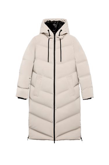 Front view of a light beige long anorak with an adjustable hood, front zip fastening and jetted front pockets.