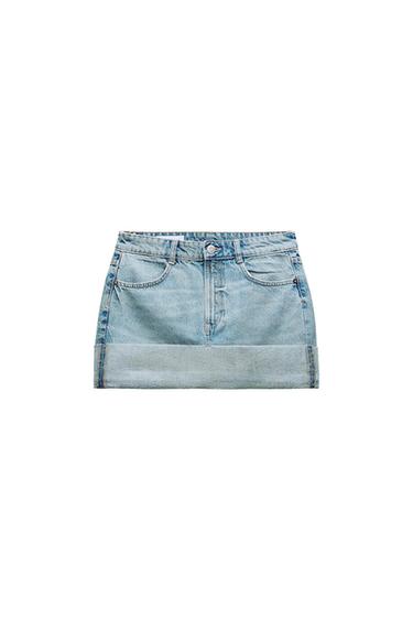 Light blue denim miniskirt with a wide hem, front pockets, and belt loops, on a white background.