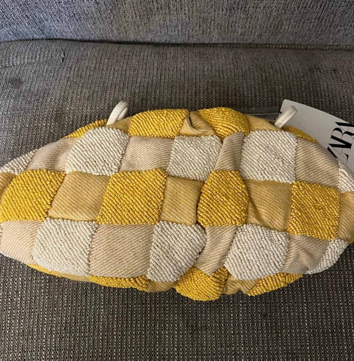 Close-up of a bag with a yellow and beige checkered design.