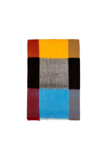 Large checked scarf in red, yellow, black, grey, and blue, on a white background.