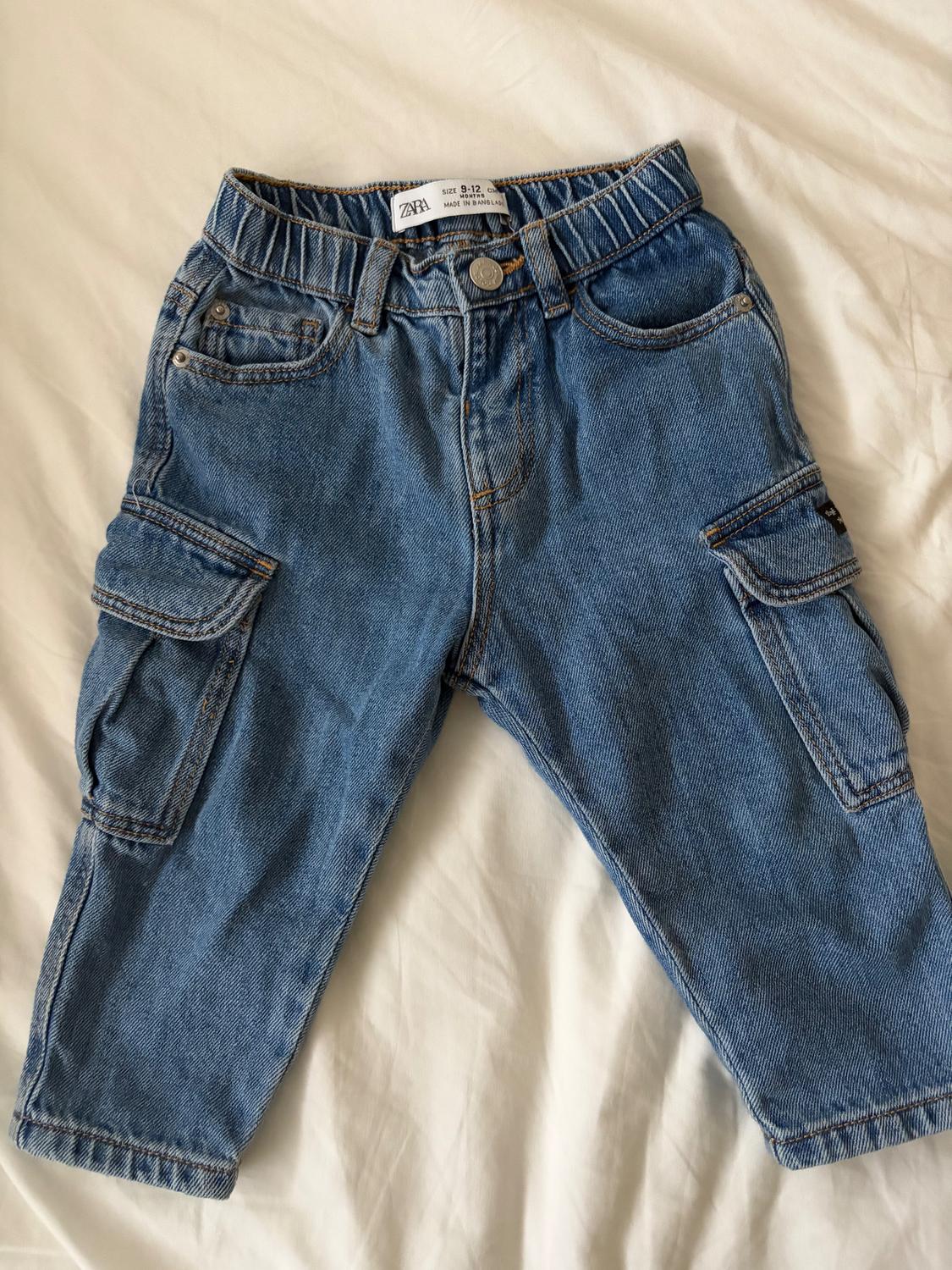 Blue denim jeans for children with side pockets and an elasticated waist. Visible label: "Zara, size 9-12, made in Bangladesh".