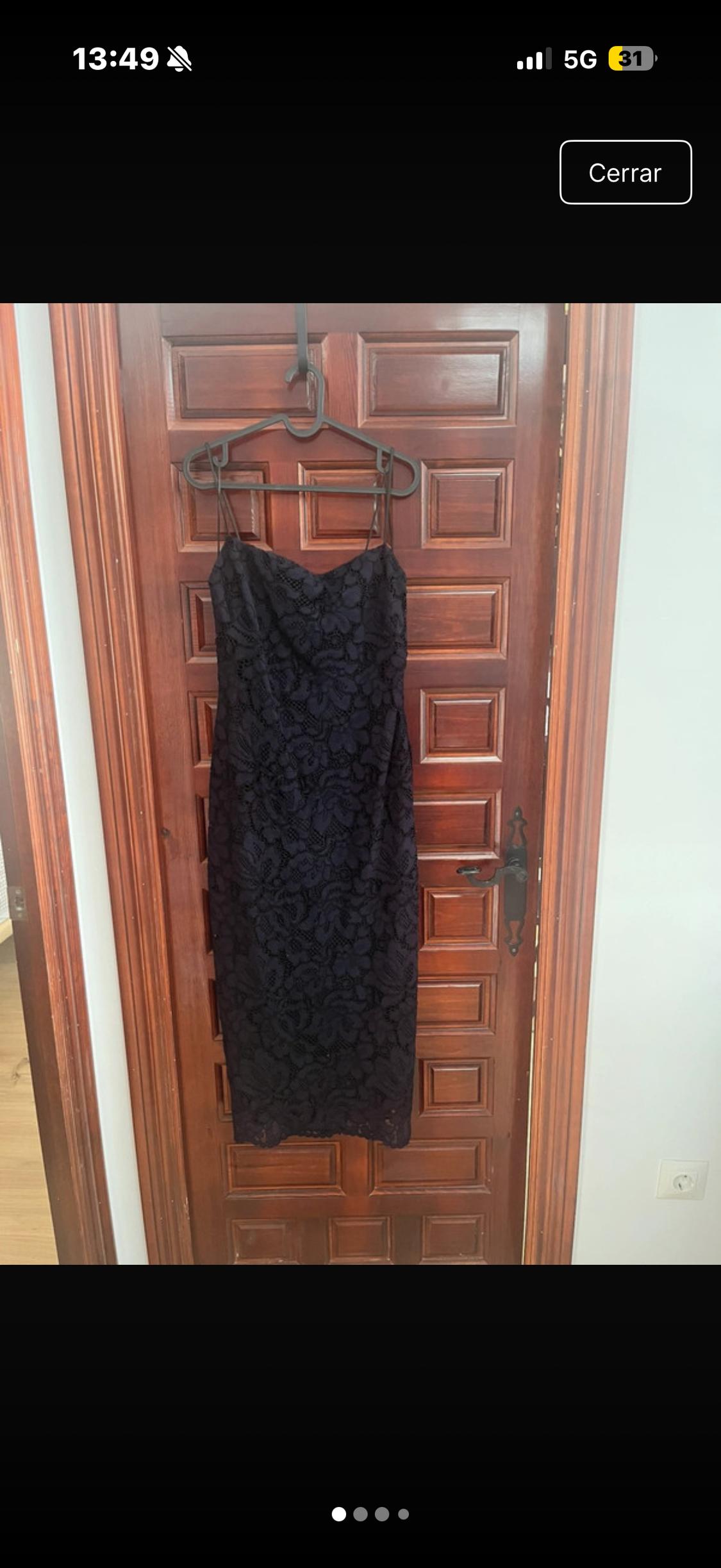 Black lace dress hanging on a wooden door. The screen shows the time 13:49 and the 5G icon. "Close" button visible.
