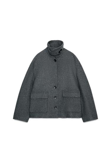 Front view of a grey jacket with a high collar, button closure, and front flap pockets.