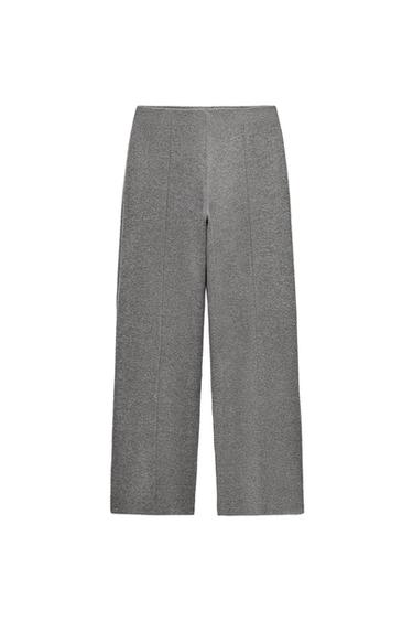 Front view of grey trousers with vertical pleats