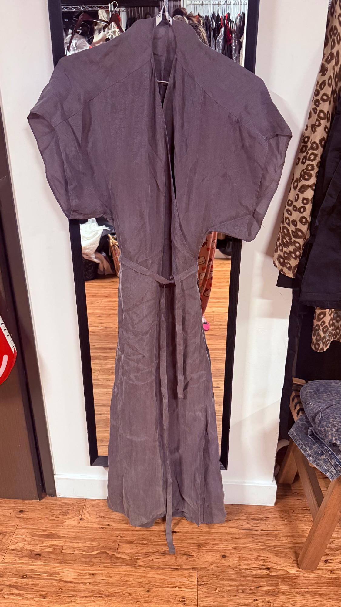 Short-sleeved gray maxi dress with a belt, hanging in front of a mirror in a walk-in closet with a wood floor.