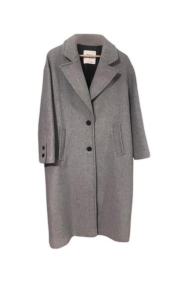 Front view of grey coat with lapels, a two-button fastening and side pockets.