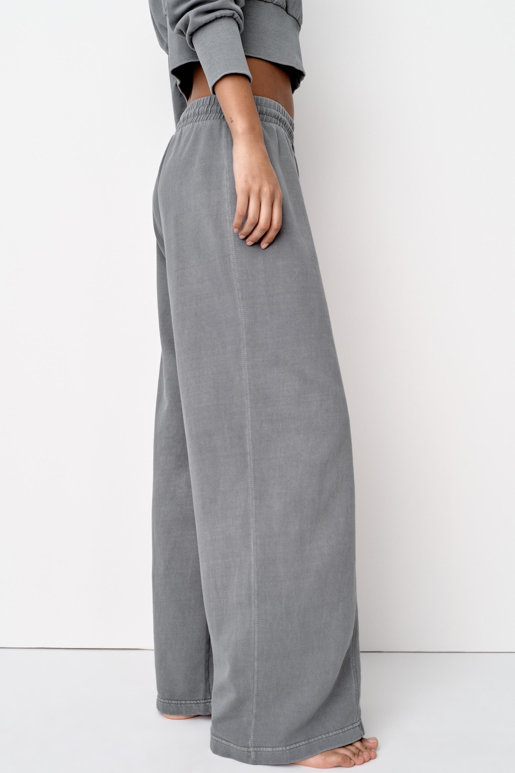 Pants with a high waist with adjustable elastic drawstring waistband.  Straight leg and pronounced seams.