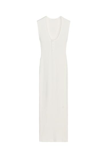 Front view of a sleeveless white dress with a U-neckline and buttons on the chest
