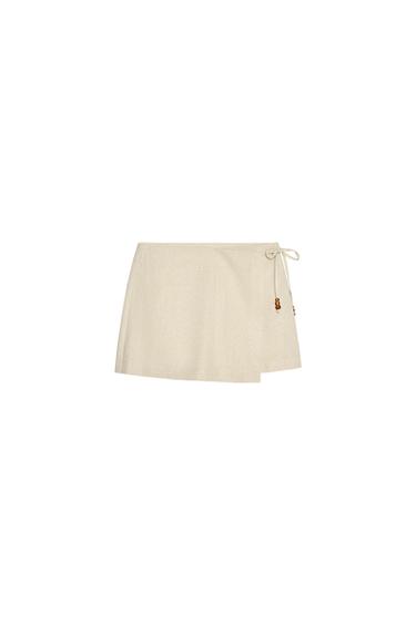 Front view of beige skirt with side tie.