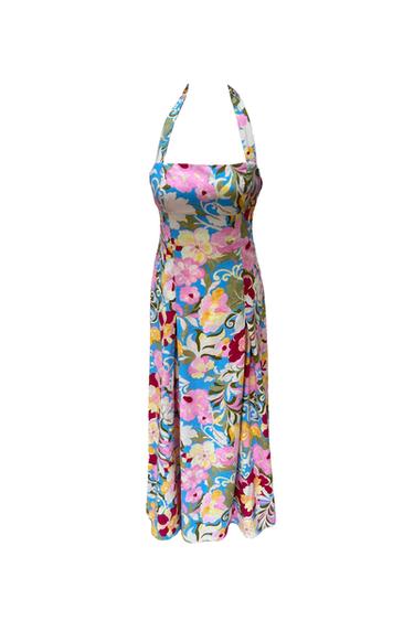 Sleeveless maxi dress with a halter neck. It features a multicoloured floral print in shades of pink and yellow against a light blue background.