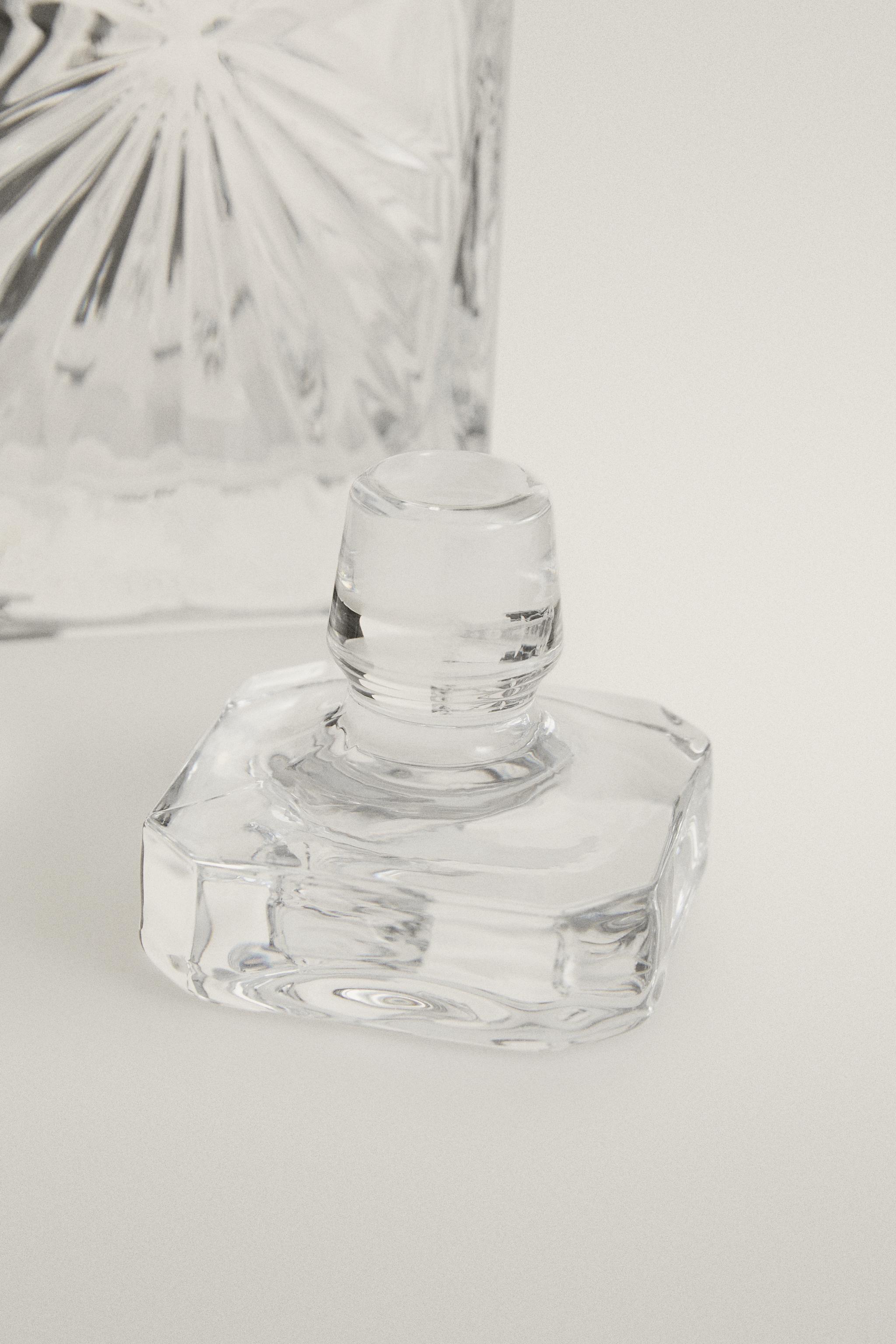 CRYSTALLINE BOTTLE WITH RAISED DESIGN