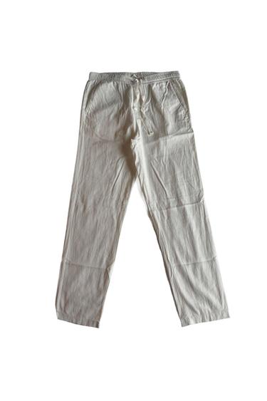 Straight-cut long white pants with an elastic waist and adjustable drawstring, presented against a white background.