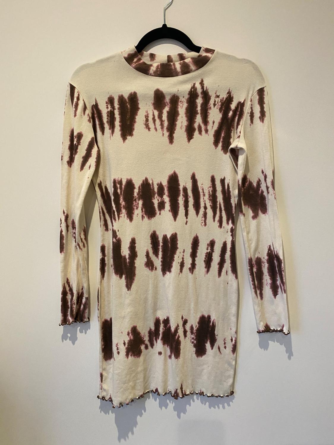 Rear view of brown and white tie-dye print long-sleeved dress with round neck and wavy hem.