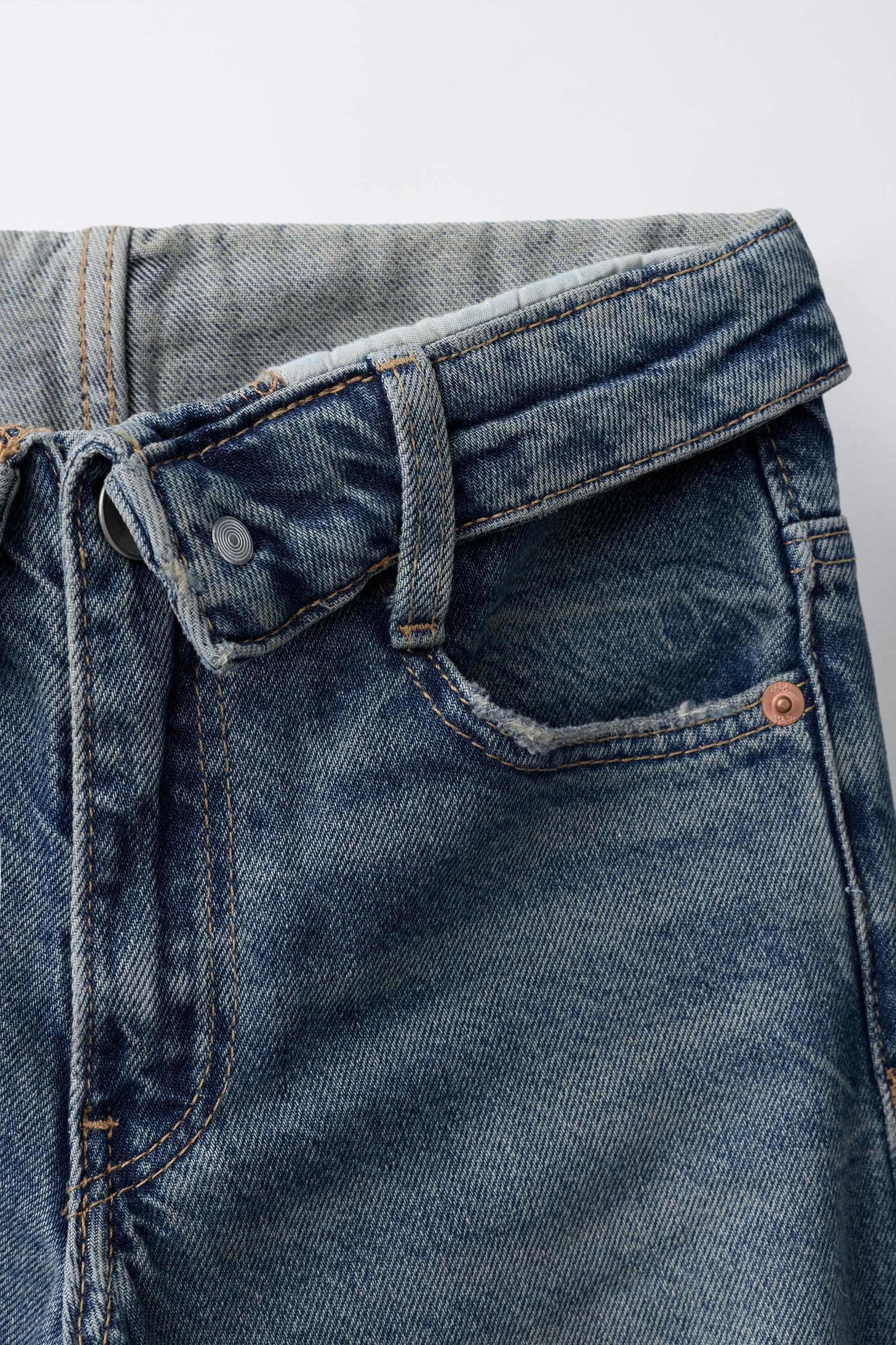 JEAN À JAMBES LARGES DÉCHIRÉ