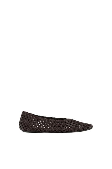 Dark brown braided flat shoe, seen in profile against a white background.