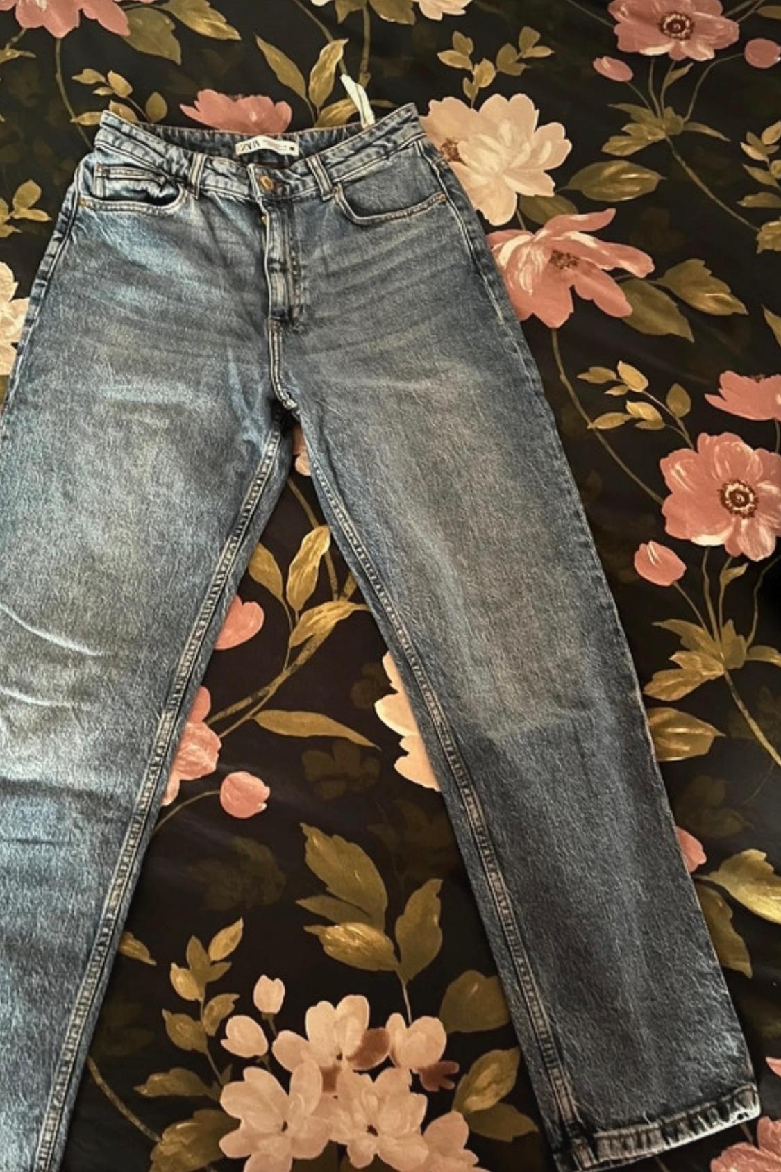 Front view of blue jeans with front and back pockets.