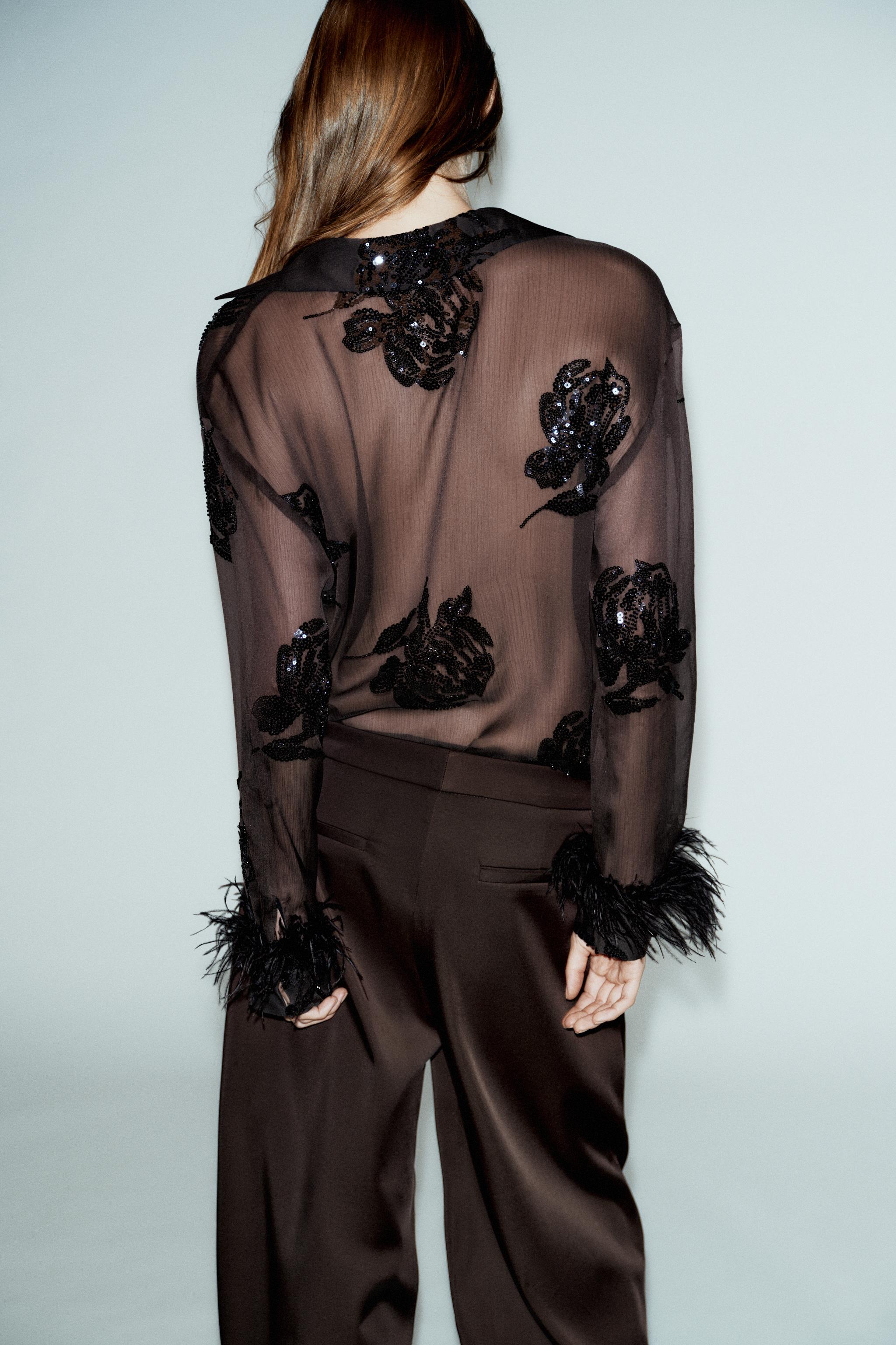 BLOUSE SEMI-TRANSPARENTE PAILLETTES PLUMES