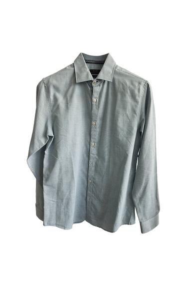 Light blue long-sleeve button-down shirt on a white background.
Interior label with the text ZARA.