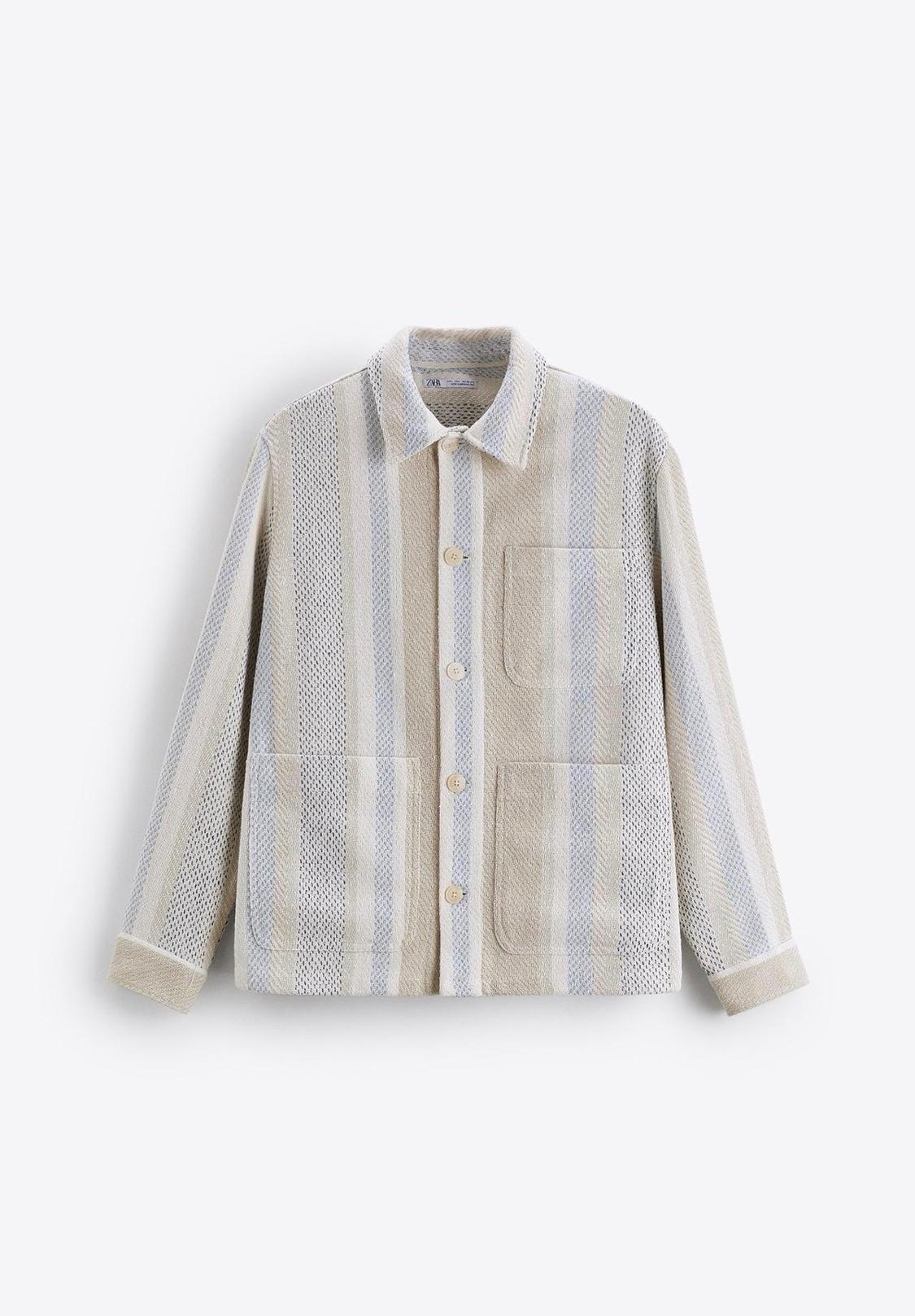 Vertical striped jacket in beige and light blue tones, with front buttons and large pockets, on a white background.