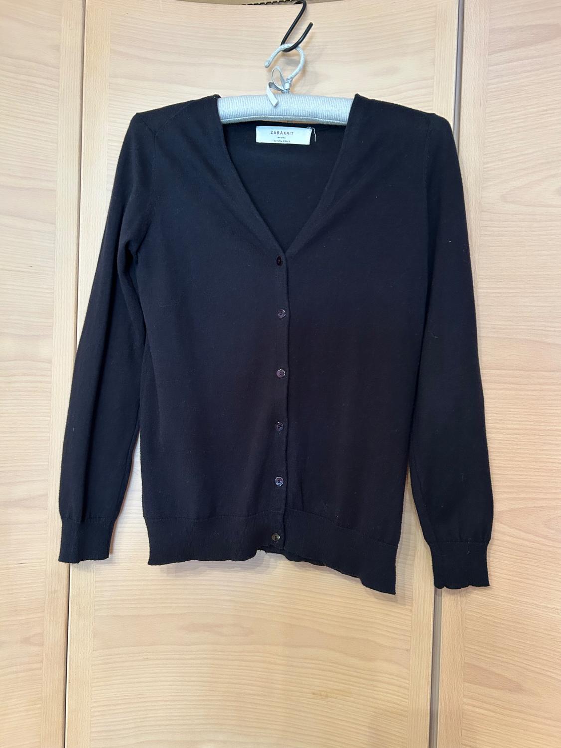 Front view of a black cardigan with buttons and a V-neck.