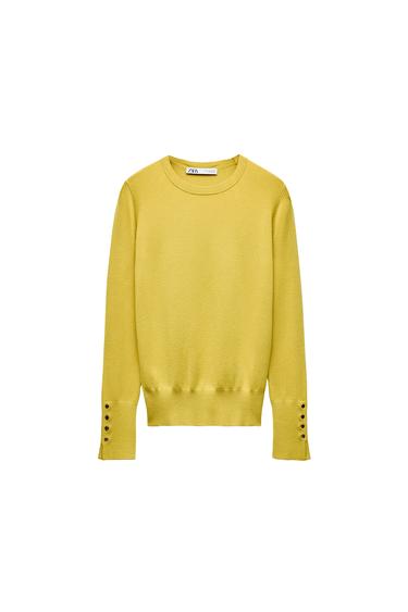 Front view of a yellow jumper with buttons on the long sleeves