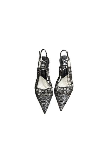 Pointed high-heeled shoes with a mesh and strap design, in black and silver. Visible text: "ZARA" on the insole.
