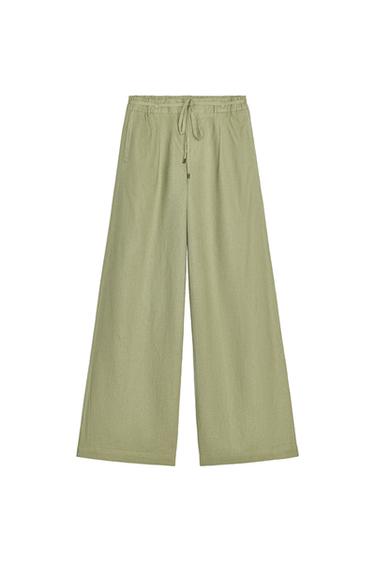 Front view of olive green pants with elastic waistband and adjustable drawstring.