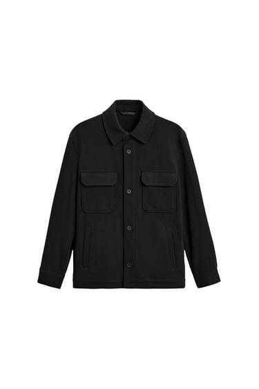 Front view of a black jacket with front flap pockets and button fastening.
