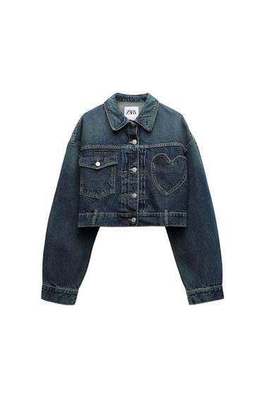 Front view of a blue denim cropped jacket with front pockets and heart detail.