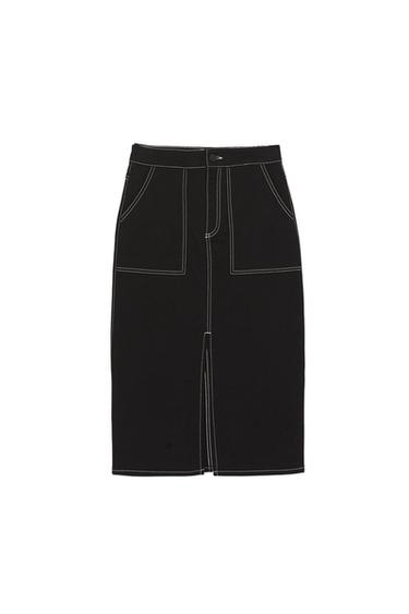 Black midi skirt with contrasting white stitching, front pockets and a front slit against a white background.