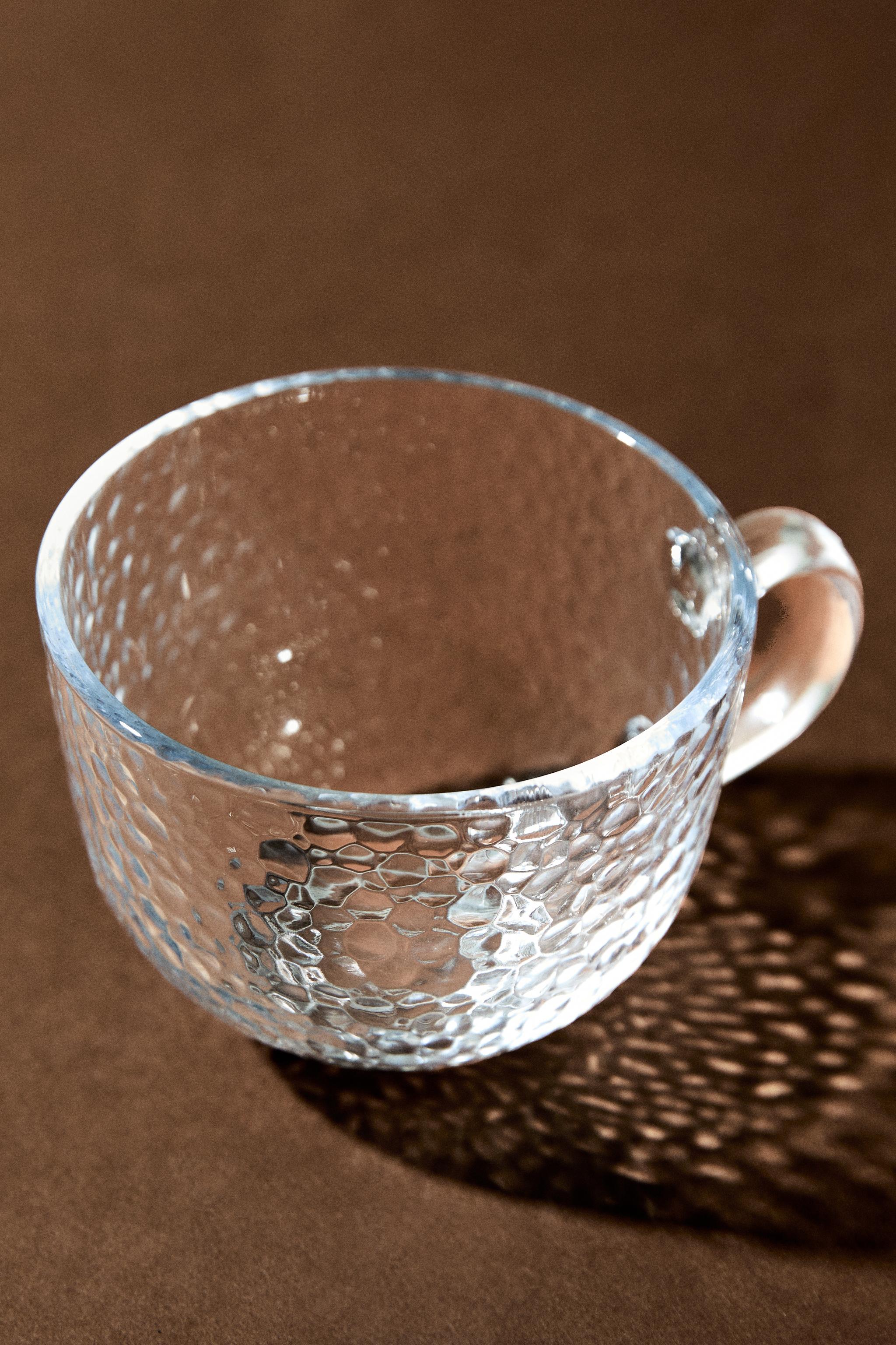 GLASS CUP WITH RAISED DESIGN