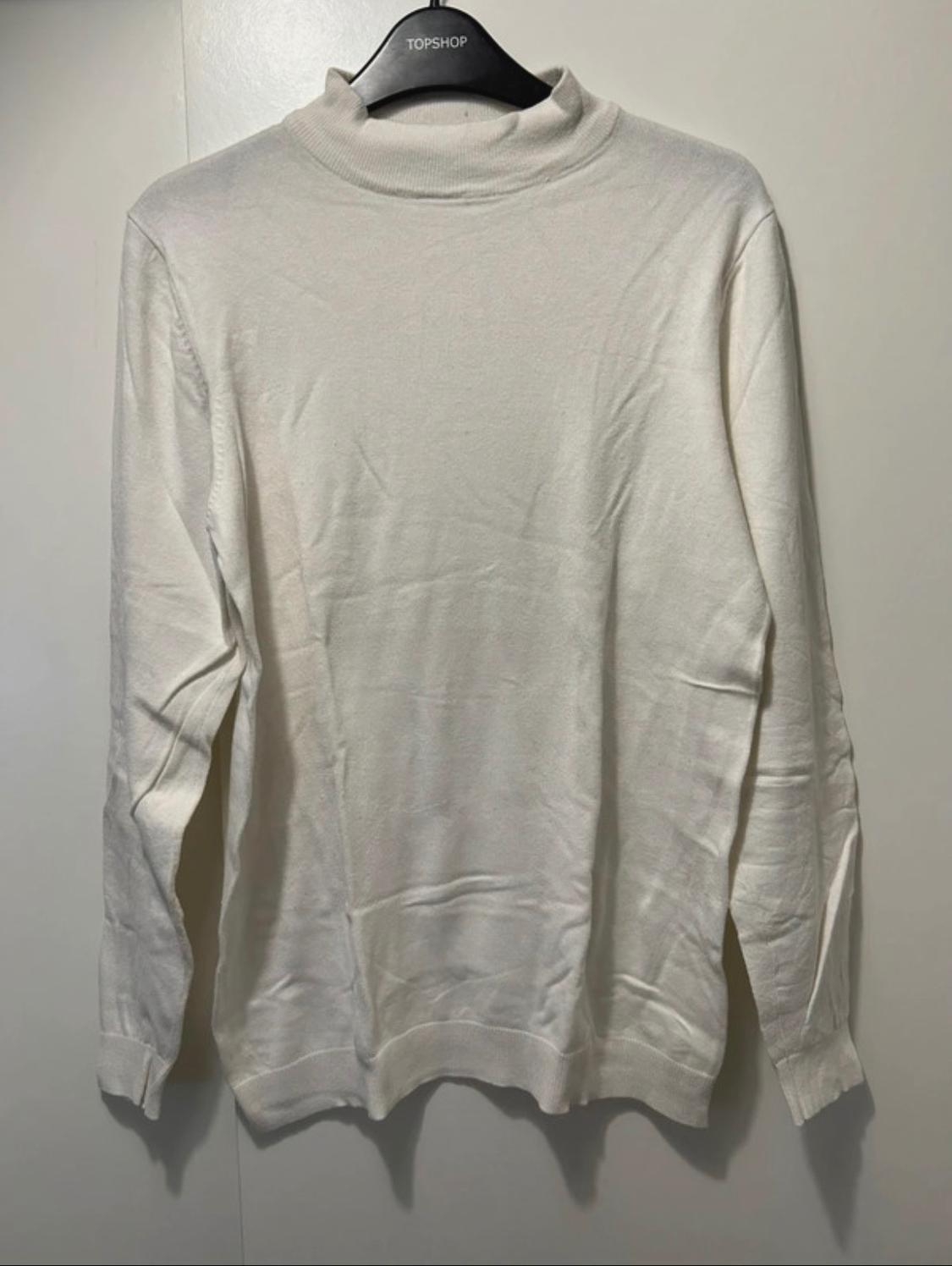 White long-sleeved polo neck jumper, hanging on a black Topshop hanger against a white background.