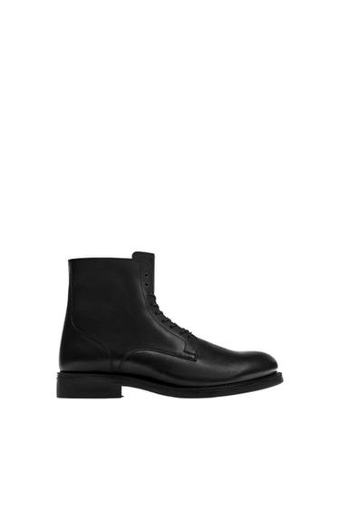 Black leather lace-up boot, side view on a white background. Classic and elegant design.